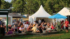 A crowded outdoor event with people seated at tables under tents. - Kleine Wohnung mit schönem Balkon by Interhome (Poreč/Funtana)