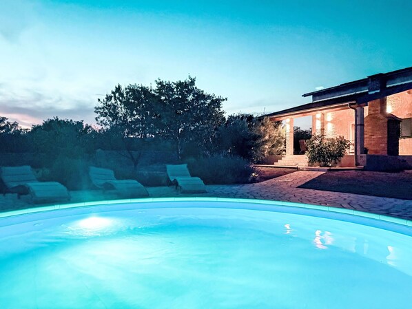 A swimming pool with lounge chairs, a covered patio, and a brick building. - Anwesen "Steinperle mit beheiztem Schwimmbad" by Interhome (Donje Rastane)