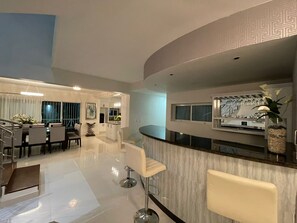 A modern kitchen with a marble countertop, a built-in oven, and a large window. - Beautiful Villa in Dominican Republic
“Aleimy” (La romana)