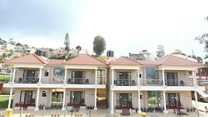 A row of two-story buildings with balconies, likely a residential complex or hotel.