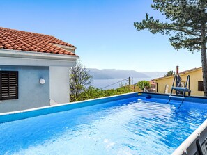 A swimming pool with a clear view of the sea and mountains in the background. - Haus Marina by Interhome (Plomin)