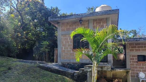 A building with a stone facade, a small dome, and a fire pit area. - Perfect 1-bedroom house in enchanting Tepoztlán for your getaway (Tepoztlán)