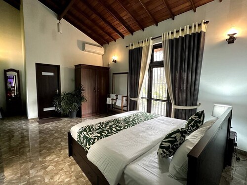 Villa with natural serenity, surrounded by lush greenery and AC comfort.