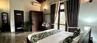 Villa with natural serenity, surrounded by lush greenery and AC comfort.