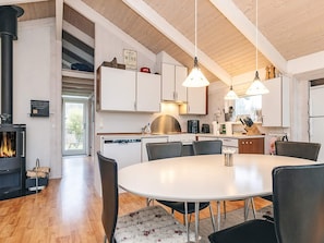 A modern kitchen with white cabinets, a central island, and pendant lighting. - 4 Star Holiday Home in Hals (Hals)