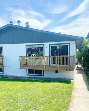 A modern two-story house with a balcony, large windows, and a visible address number 2729.