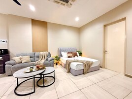 A modern bedroom with a bed, a sofa, and a coffee table.