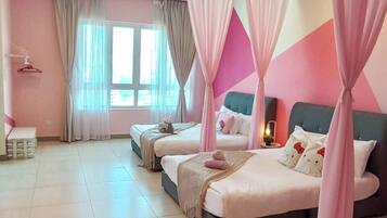 A bedroom with two beds, a vanity, and a window with curtains.