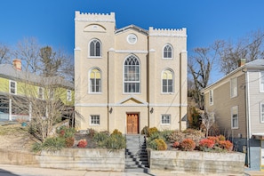 A two-story building with a symmetrical facade, arched windows, and a central entrance with a staircase. - 'The Sanctuary' in Historic Dtwn Staunton (Staunton)
