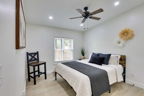 A bedroom with a bed, a chair, a ceiling fan, a window, and a wall-mounted decorative item. - Hike & Fish! Tyler Family Home 11 Mi to State Park (Tyler)