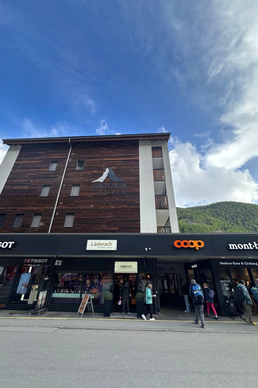 A building with a wooden facade and a sign for Victoria Center.