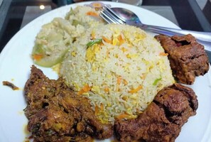 A plate of food with rice, vegetables, and meat. - Hotel Shomrat Int. Brahmanbaria (Brahmanbaria Sadar)