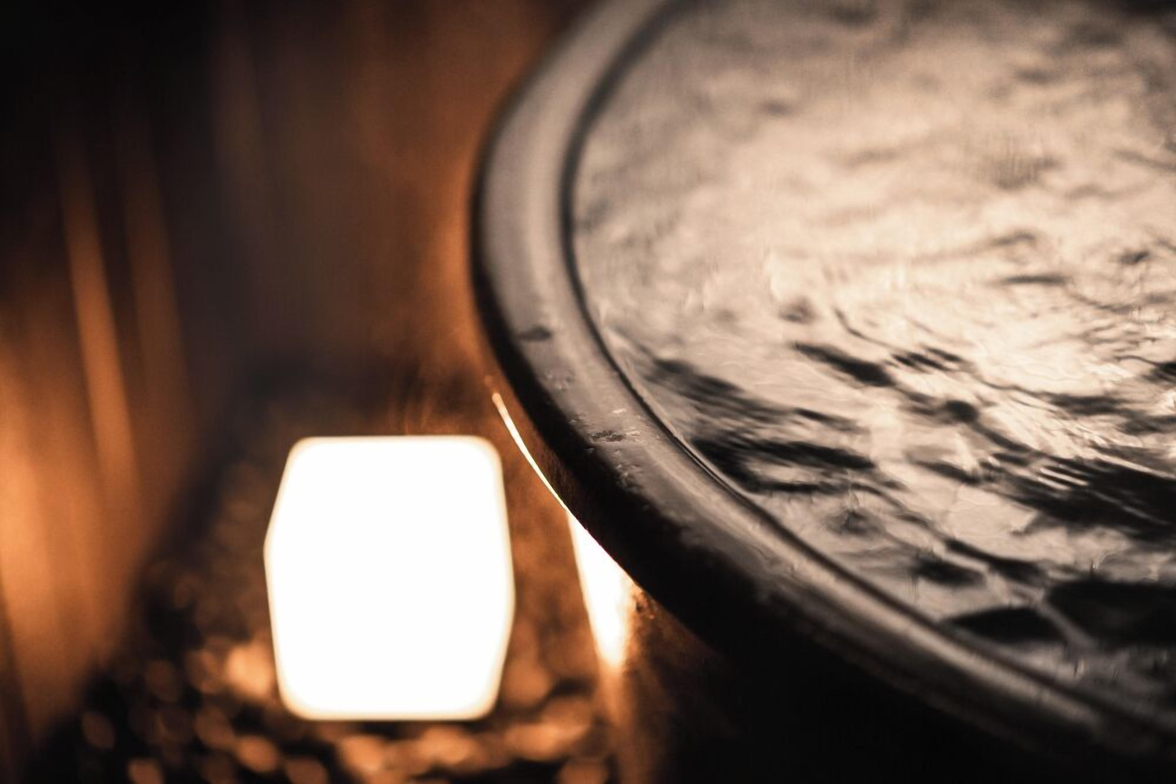 A close-up of a circular object with a textured surface, possibly a table or a part of a room's decor.