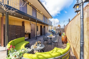 An outdoor patio area with seating, tables, and a covered section. - Hakone Mori No Sato (Hakone)