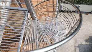 A metal spiral staircase with a metal railing. - Kishoreganj Haor Resort (Kishoreganj Sadar)