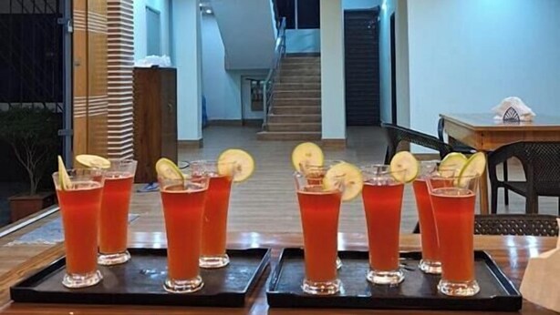 A bar area with drinks and a staircase in the background. - Kishoreganj Haor Resort (Kishoreganj Sadar)