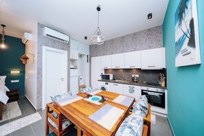 A modern kitchen with white cabinets, a microwave, and an oven. - Tropical Balcony Oasis - Soul Paje Lagoon Retreat (Paje)