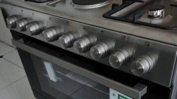 A stainless steel range with a built-in oven and a visible energy efficiency label.