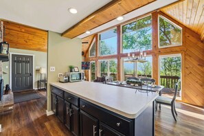 A kitchen with a large island, wooden ceiling, and large windows. - Views of Blue Mountain! Near App Trail, Game Room (Palmerton)