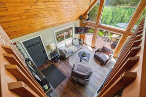 A spacious living area with a sofa, armchairs, a coffee table, and a TV mounted on the wall. - Views of Blue Mountain! Near App Trail, Game Room (Palmerton)