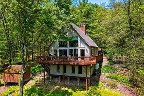 A two-story wooden cabin with a balcony, surrounded by dense forest. - Views of Blue Mountain! Near App Trail, Game Room (Palmerton)