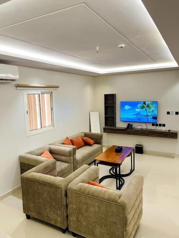 Apartment | Living area | 55-inch flat-screen TV with digital channels - Calm Serviced Apartments 4 (Riyadh)
