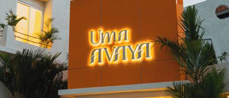 A building with a large illuminated sign reading "UMI ANAYA".