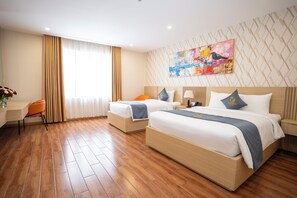 A hotel room with two beds, a desk, and a chair. - Cannes Hotel (Phu Khuong)