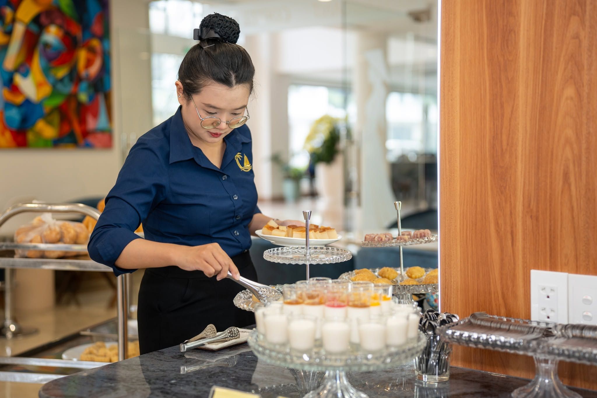 A buffet setup with various food items and serving utensils.