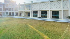 A modern building with a flat roof, large windows, and a central courtyard. - The Manak Bagh (Sehore)