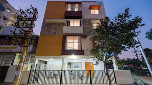 A multi-story building with balconies and a gated entrance. - Hotel Royal Manyaa (Bengaluru)