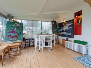 A spacious art studio with large windows, wooden floors, and various art supplies and paintings. - La maison du cavalier bleu by Interhome (Deauville-Trouville)