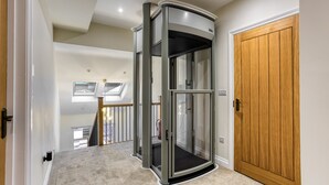 Een modern interieur met een draaideur, een houten deur en een vloerbedekking.