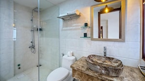 A modern bathroom with a glass-enclosed shower, a marble sink, and a large mirror. - Dory Hotel (Hoi An)