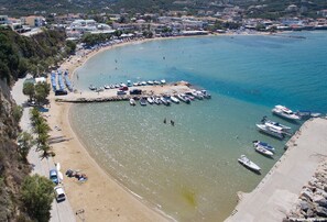 A coastal area with a beach, boats, and a pier. - LP Almyrida - 7 minutes walk from the beach (Almyrida)