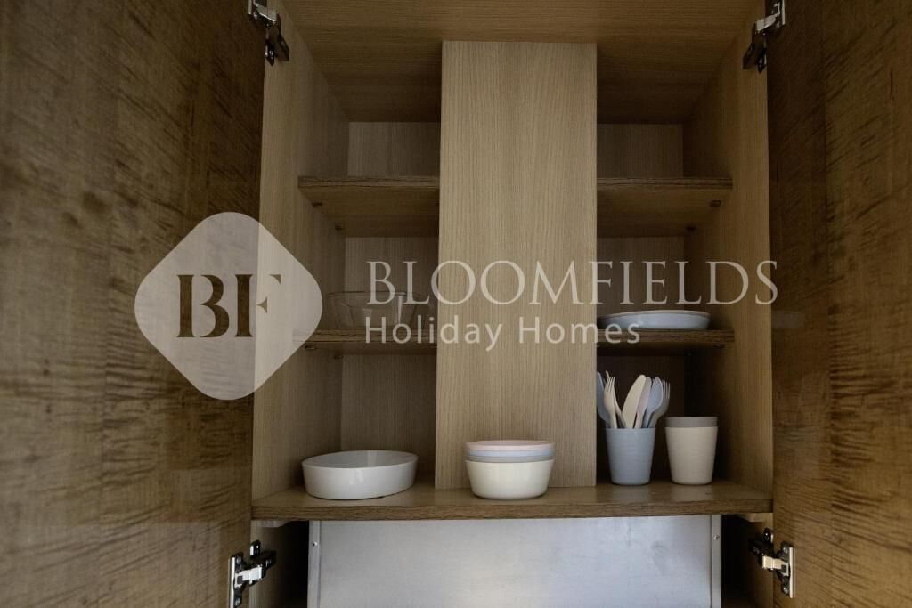 A wooden cabinet with shelves, a central divider, and a lower compartment.
