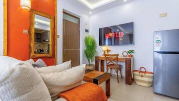 Superior Studio Suite | Living area | Flat-screen TV