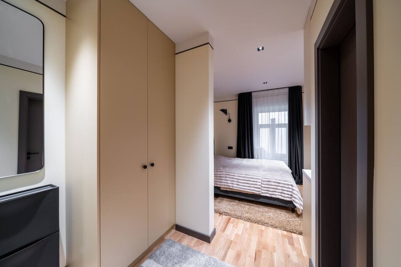 Una camera da letto con un letto, un armadio e uno specchio.
