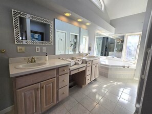 A modern bathroom with a large vanity, a bathtub, and a walk-in shower. - Cloud 10 at Rumbling Bald (Lake Lure)