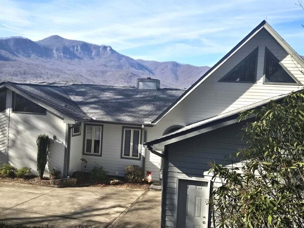 A residential house with a sloped roof, a garage, and a driveway. - Cloud 10 at Rumbling Bald (Lake Lure)