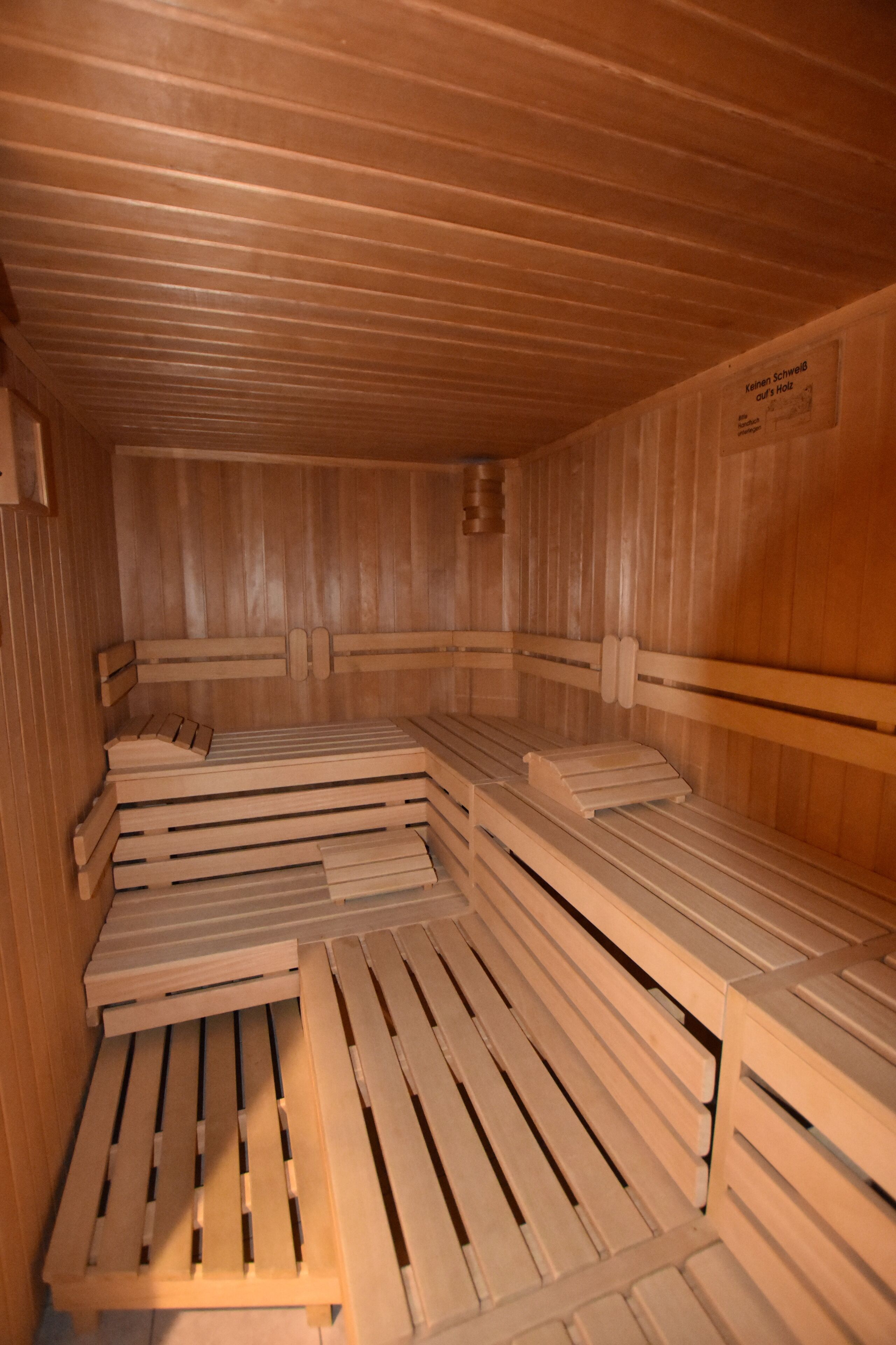 A sauna with wooden benches and benches.