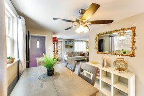 A dining area with a ceiling fan, a dining table with chairs, a potted plant, and a white console table with shelves. - Pet Friendly, Private! Multi-level Brookline Home (Pittsburgh)