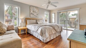 A bedroom with a bed, a nightstand, a chair, a desk, and a balcony with a view of the outside. - 9 Mi to Wdw: Resort-style Townhome w/ Pool Access (Davenport)