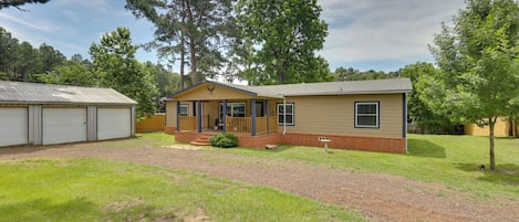 A single-story house with a front porch, a garage, and a well-maintained lawn.