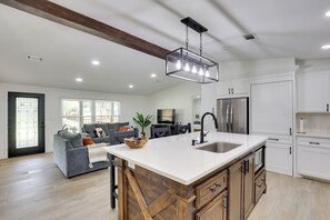 A modern kitchen with a large island, stainless steel appliances, and a farmhouse-style ceiling. - Hike & Fish! Tyler Family Home 11 Mi to State Park (Tyler)