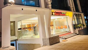 A hotel named "Hotel Hamama" with a prominent sign, a visible entrance, and a storefront with a sandwich display. - Grand Khalifa Hotel Hamama (Sylhet)