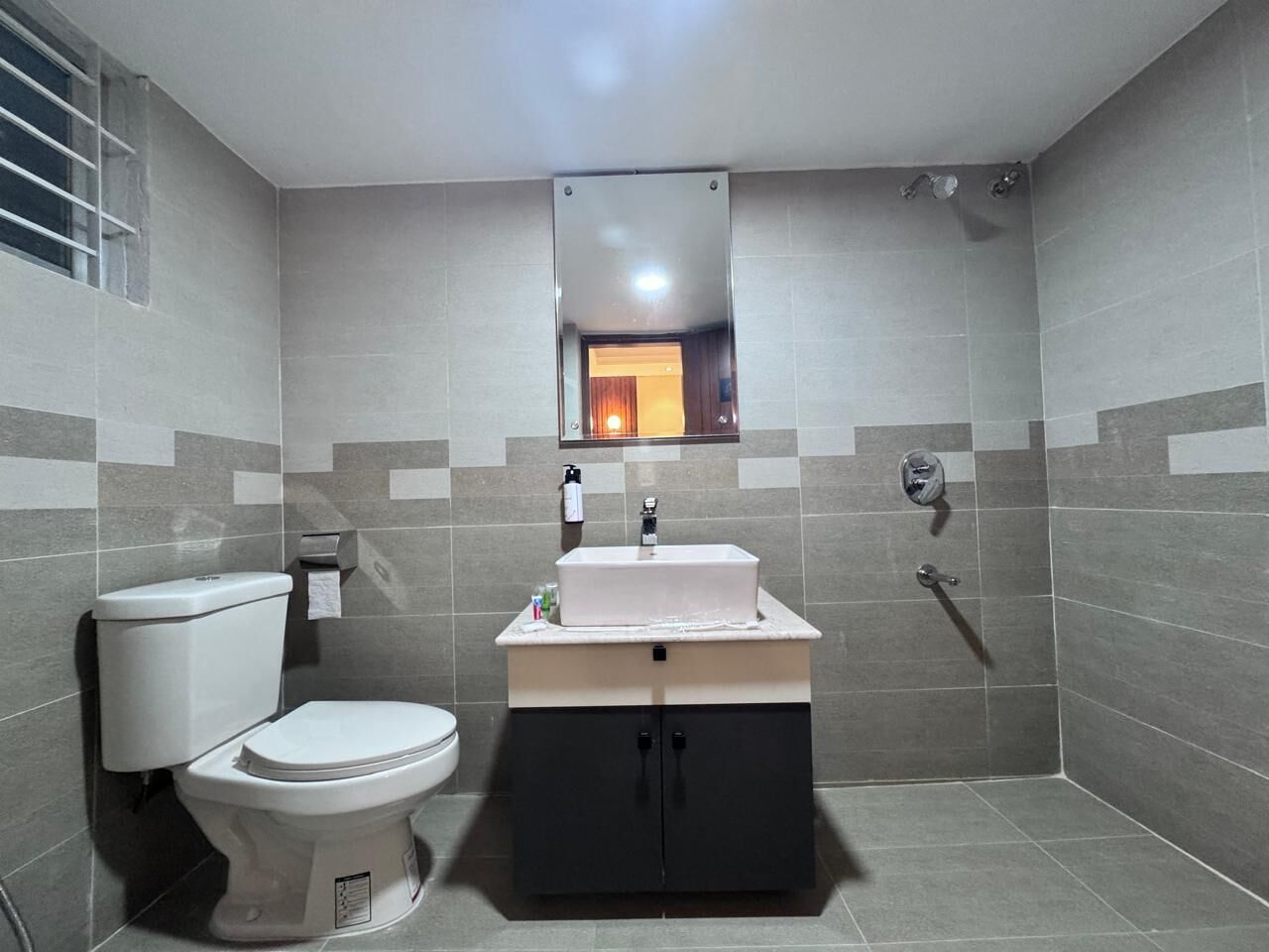 Shower, hair dryer, slippers, towels