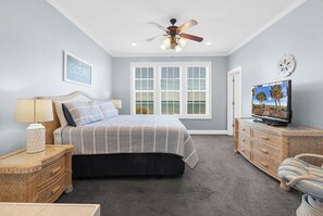A bedroom with a bed, a ceiling fan, a TV, a dresser, and a window with blinds. - DIRECT OCEAN FRONT 5 Bed 6 Bath with Pool (Surfside Beach)