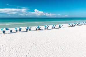 A beach with rows of sun loungers and umbrellas. - Island Princess 607 3 Bedroom Condo (Fort Walton Beach)