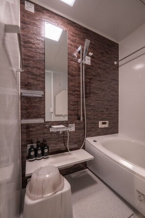 A modern bathroom with a large mirror, a shower, a bathtub, and a sink with toiletries. - Private Residence Kyoto Station North (Kyoto)